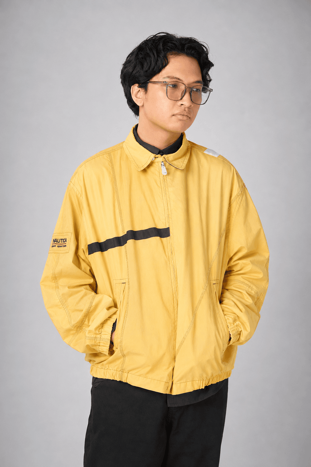 Joseph Gabriel Castro wearing glasses and a yellow jacket